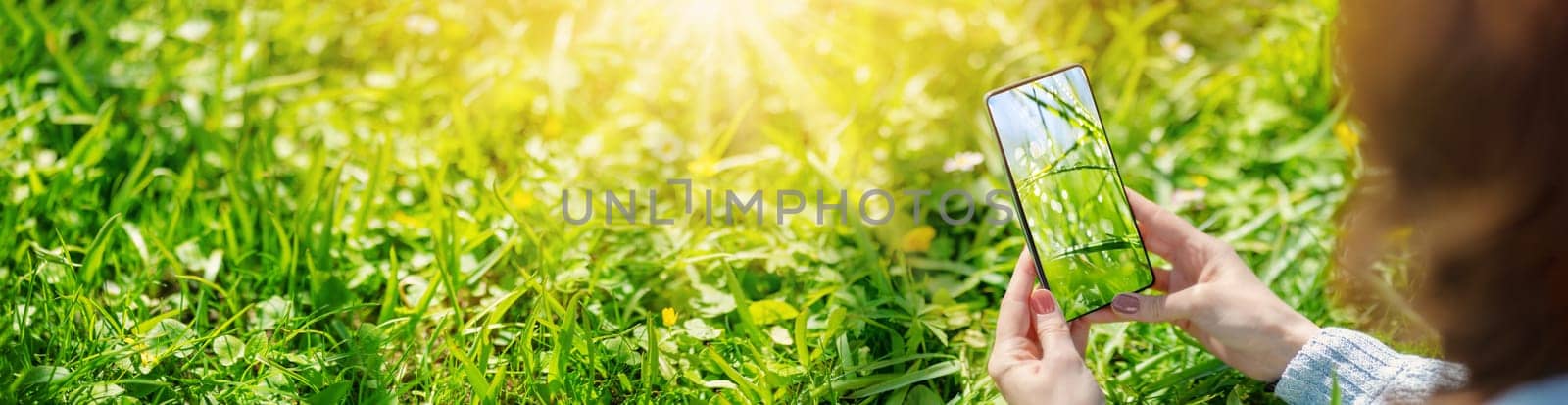 Woman making photos of the nature in sunny day. Concept of the photographing and vacation.