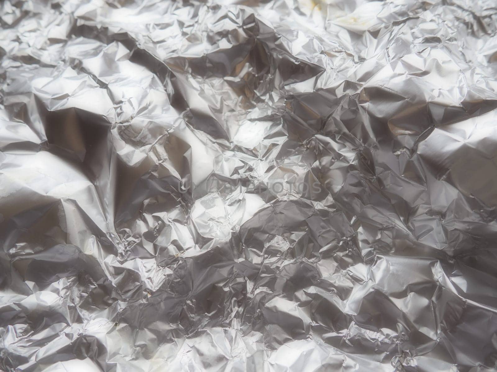 foil close-up. Aluminum silver crumpled foil. Abstract metallic background. Foil for baking food. Background. Soft focus.