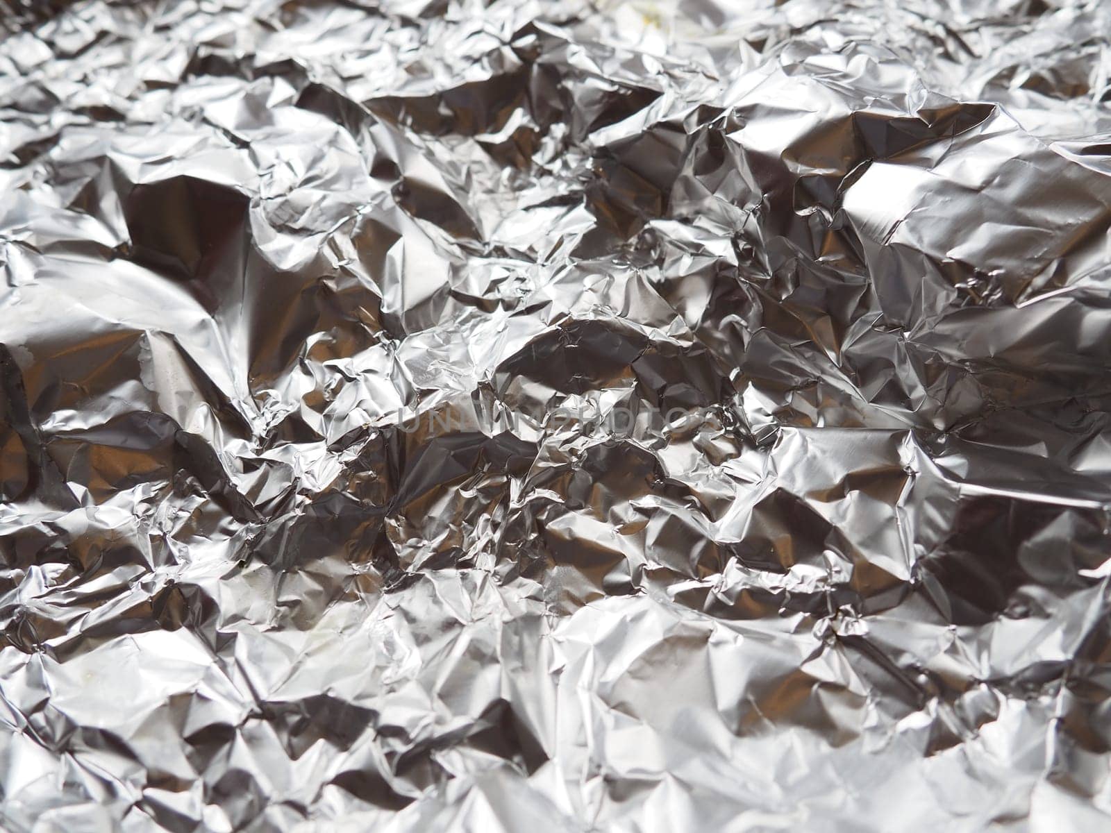 foil close-up. Aluminum silver crumpled foil. Abstract metallic background. Foil for baking food. Background.