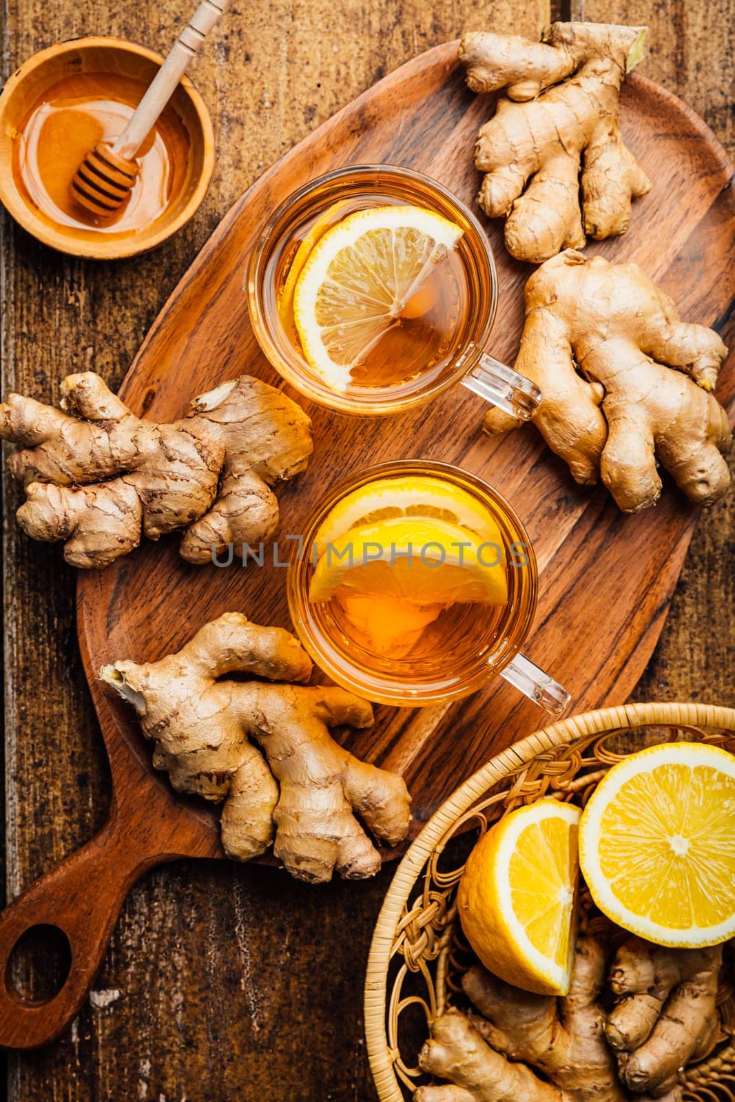 Ginger tea with lemon and honey on a wooden table