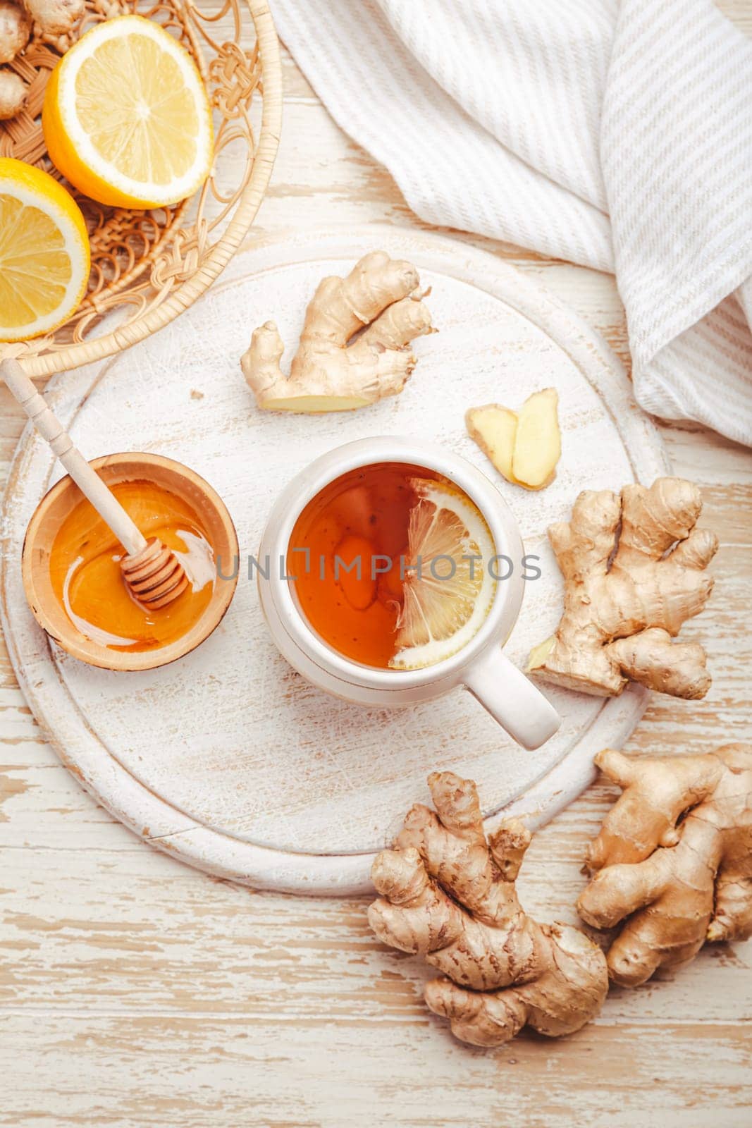 Ginger tea with lemon and honey on a wooden table