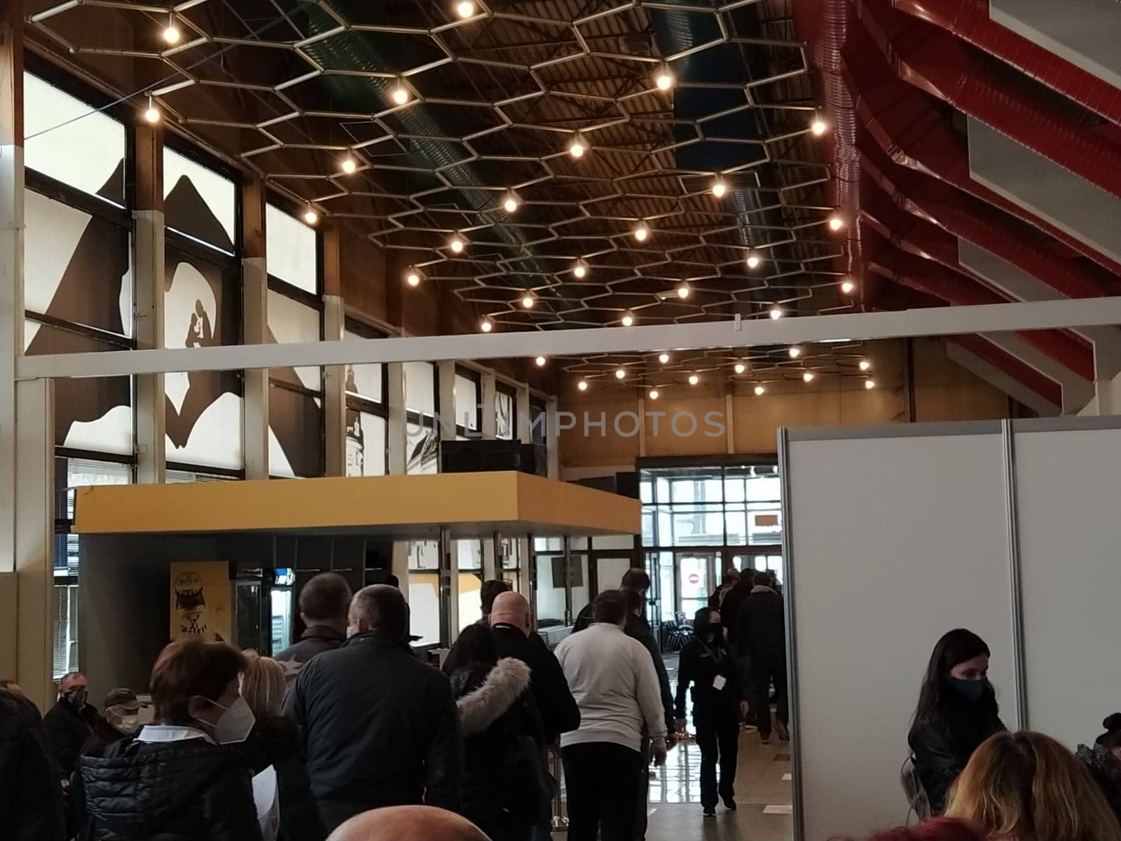 Sremska Mitrovica, Serbia. March 13, 2021 Covid-19 vaccination. Senior patient receiving coronavirus vaccination. Nurses record people data. People in protective masks waiting for the vaccine