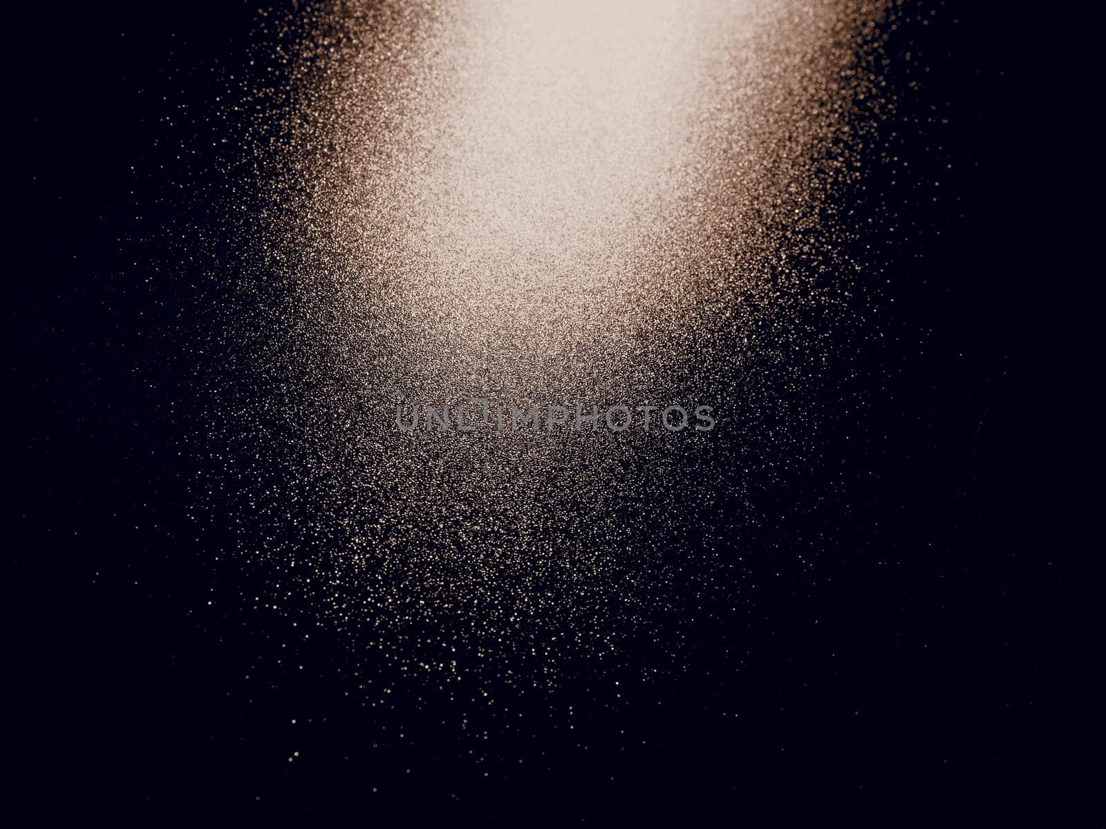 bokeh and beam on a black background. Blurred glow from above on a dark surface. Night or space theme. Bokeh for the holiday. Abstract background. Glare, ray and light shine from above. Sepia.