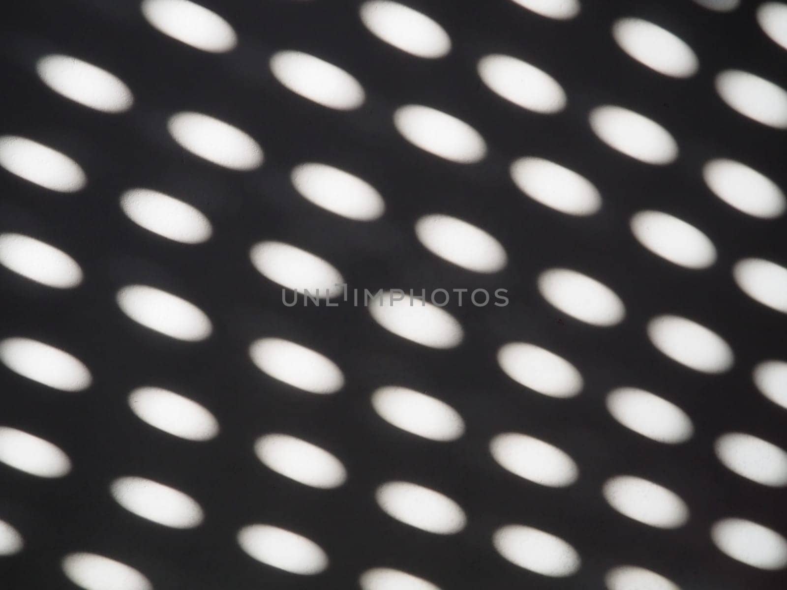 abstract sun bunnies ovals. Black and white trendy ugly. Retro or disco style. Abstract background with different blurred sun glare passing through the holes of the blinds or shutters.