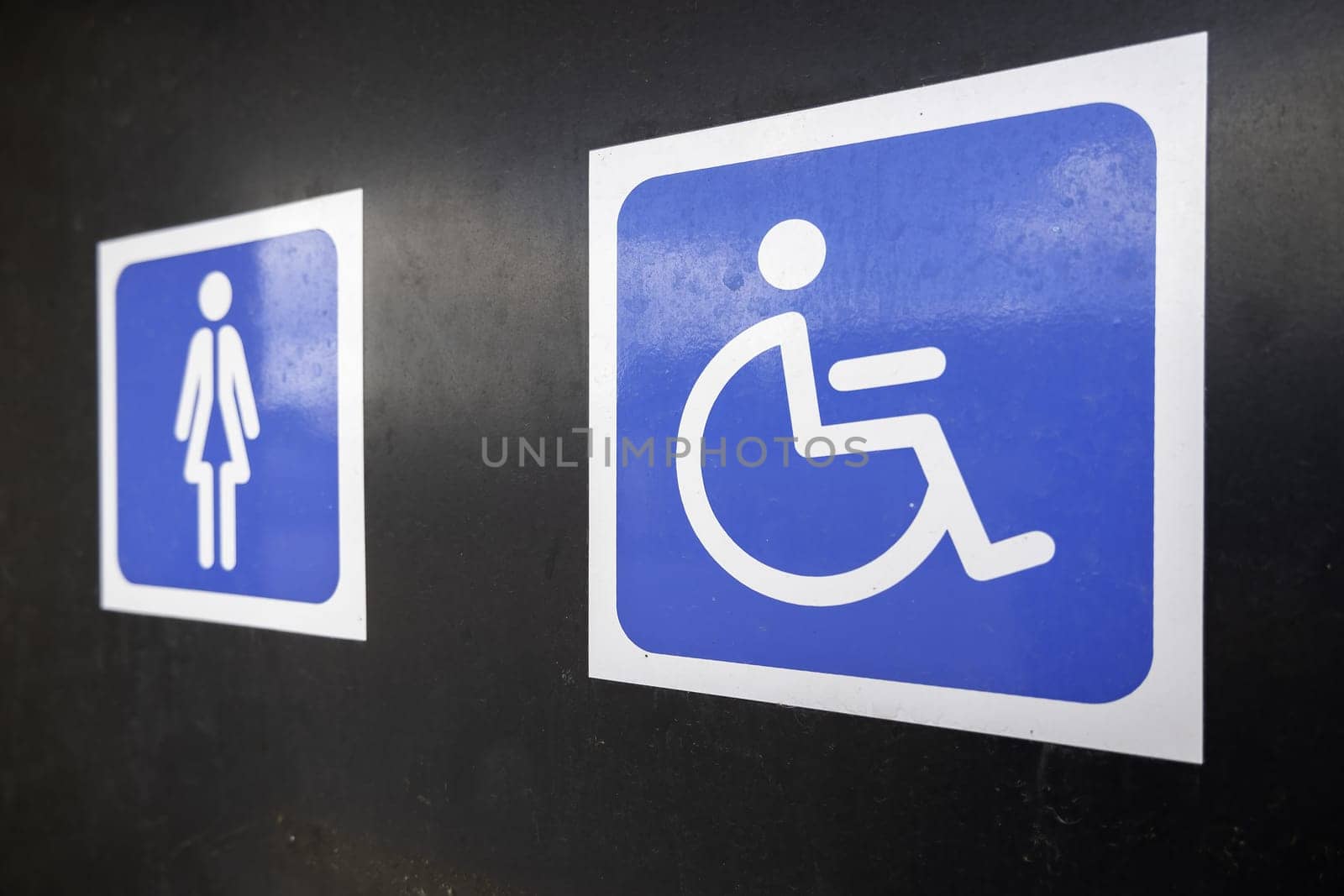 Sign detail for handicapped access in a public bathroom in the city