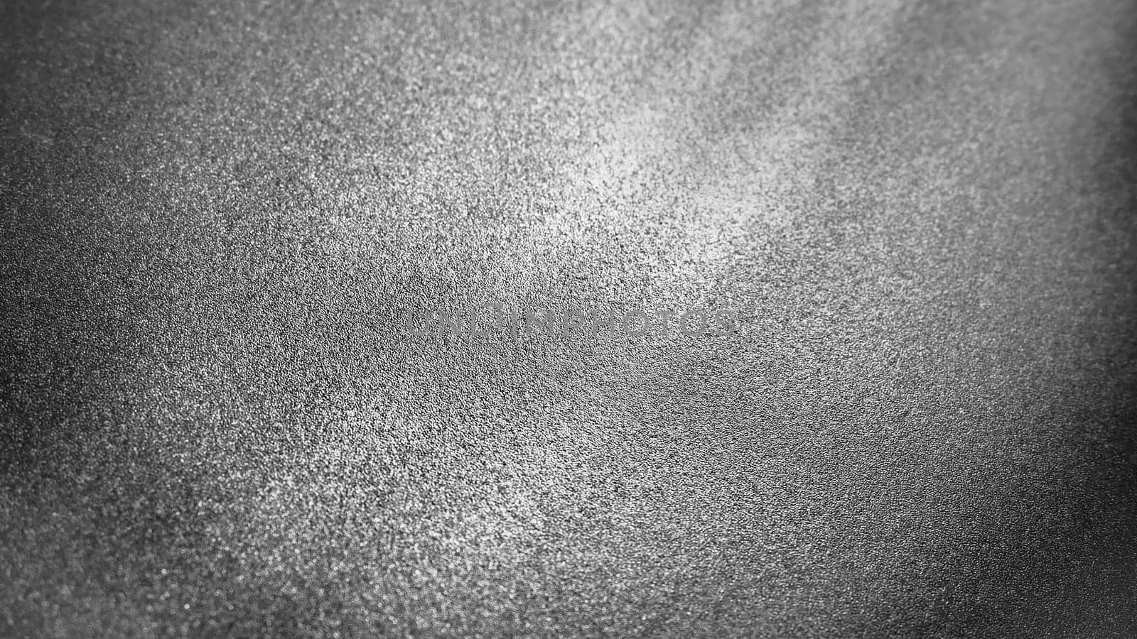 Abstract gray background with gradient, coarse grain. Selective focus. Blurred backdrop with dots and glow