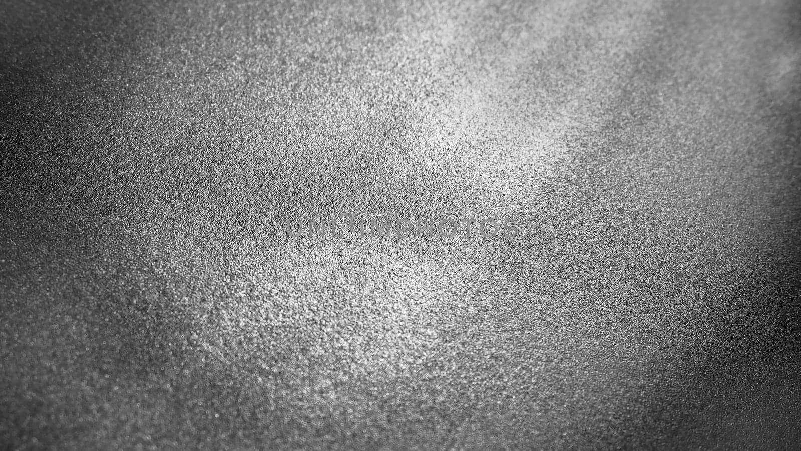 Abstract gray background with gradient, coarse grain. Selective focus. Blurred backdrop with dots and glow