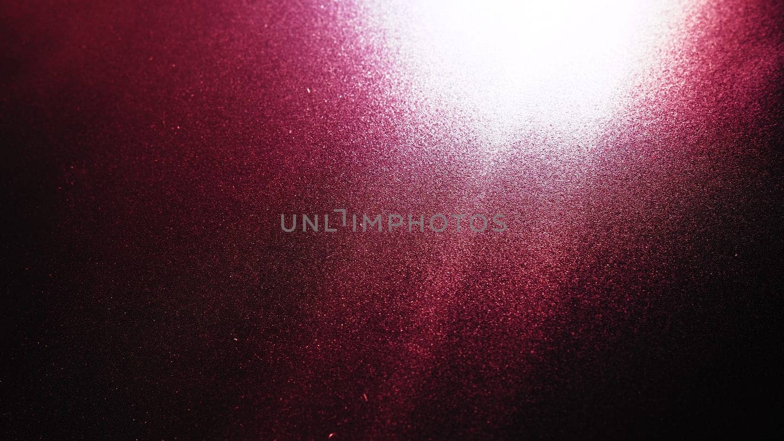 Diagonal rays of light on a red, burgundy and black background. Blurred abstract background light effect and leaks. Side surface illumination. Parallel and asymmetric lines, stripes of light at angle