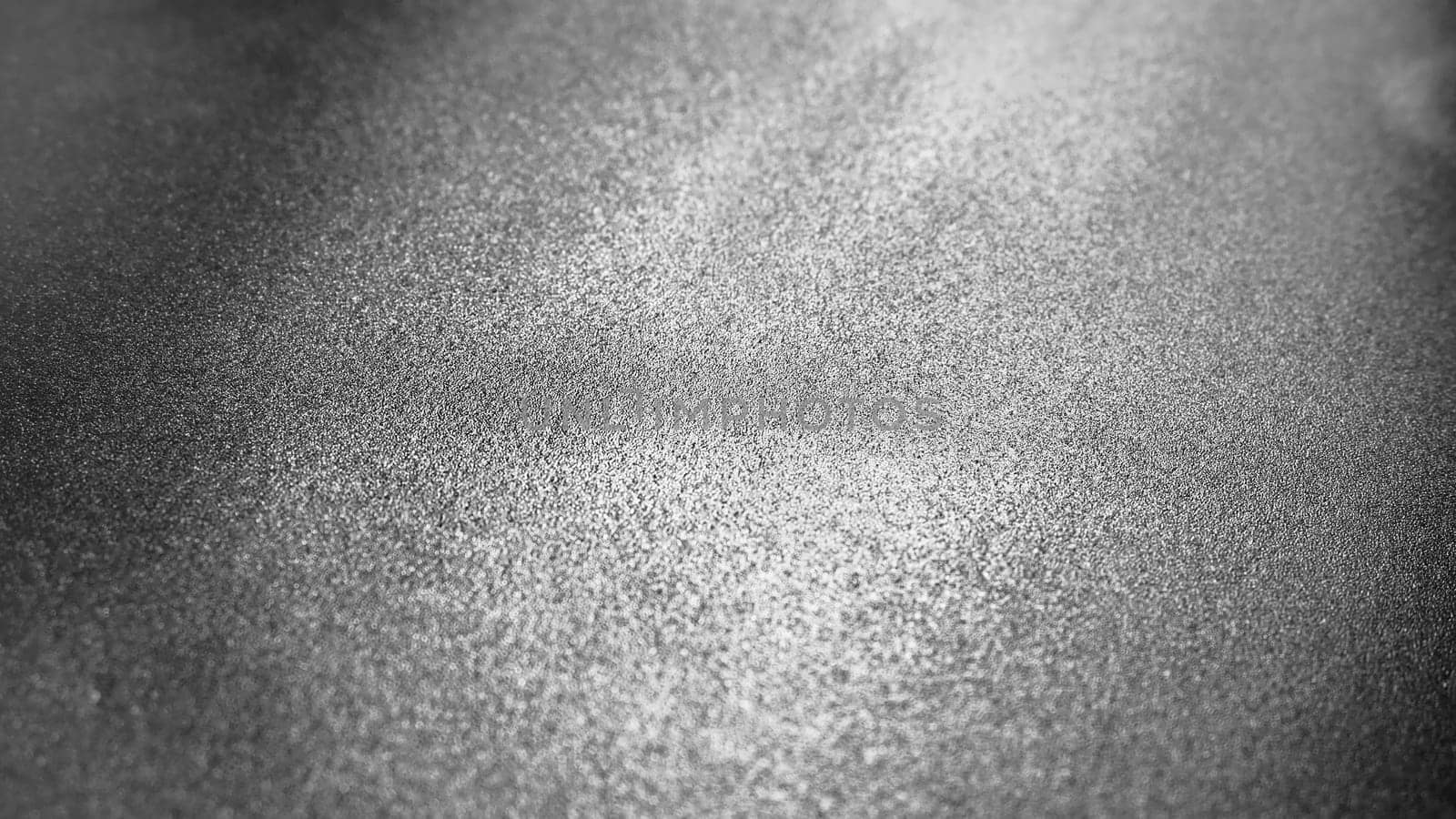 Abstract gray background with gradient, coarse grain. Selective focus. Blurred backdrop with dots and glow