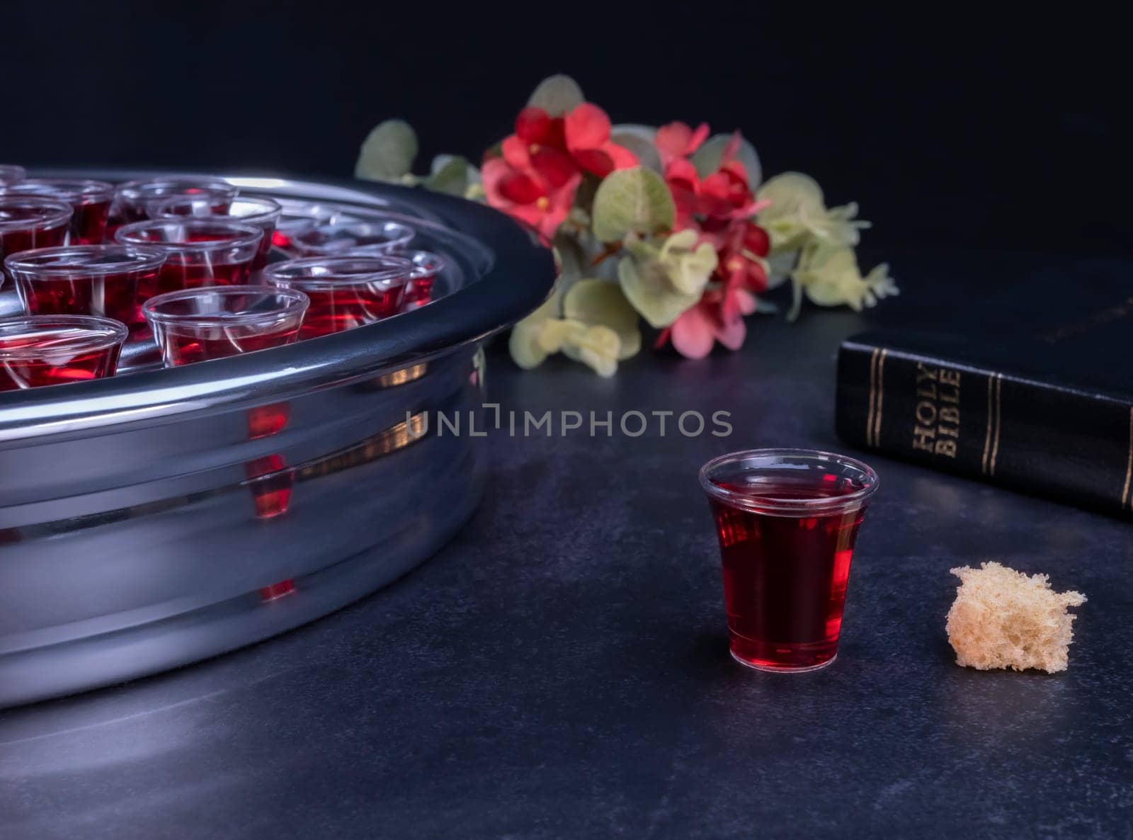 Taking communion concept - the wine and the bread symbols of Jesus Christ blood and body with Holy Bible. Easter Passover and Lord Supper concept.