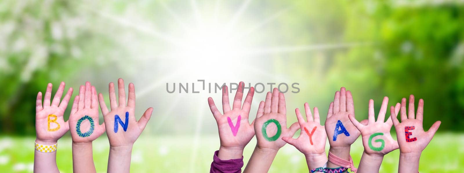 Children Hands Building Colorful French Word Bon Voyage Means Have A Good Trip. Sunny Green Grass Meadow As Background.