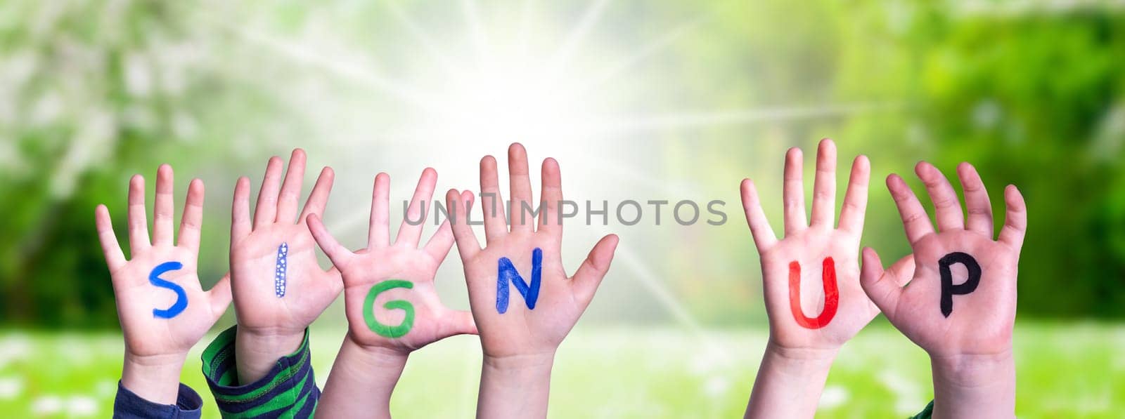 Children Hands Building Colorful English Word Sign Up. Summer, Sunny Green Grass Meadow As Background