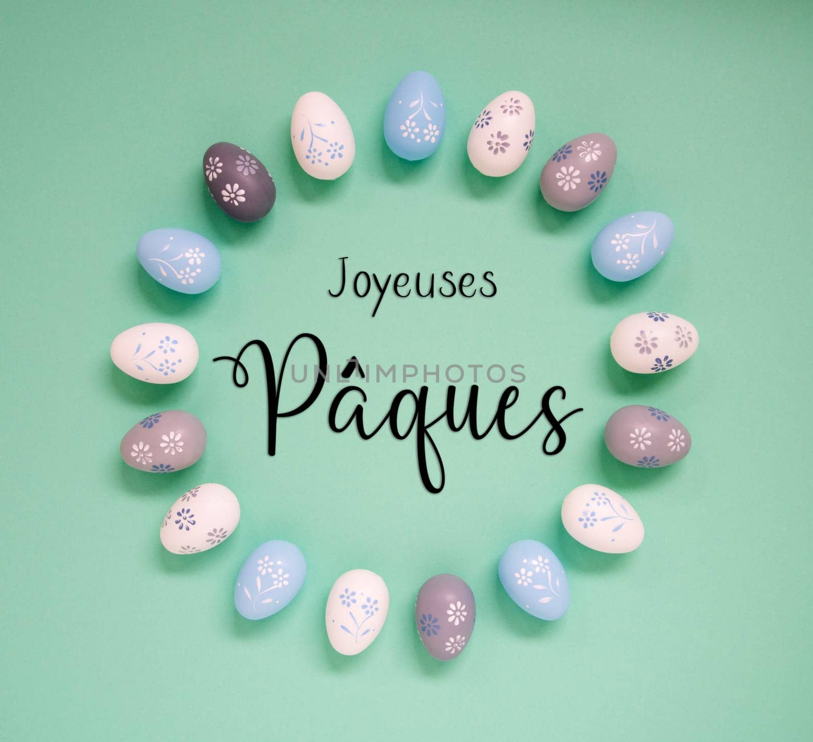 Flat Lay With French Text Joyeuses Paques Means Happy Easter. Easter Egg Arrangement, Decoration And Ornament. Light Green Paper Background