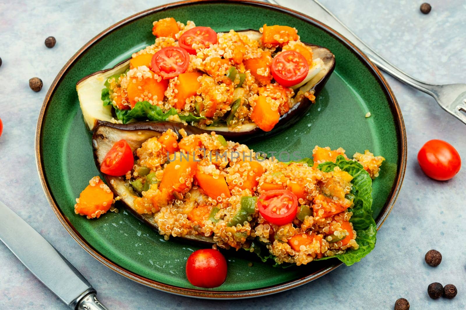 Baked eggplant stuffed with pumpkin and quinoa. Vegetarian food recipe