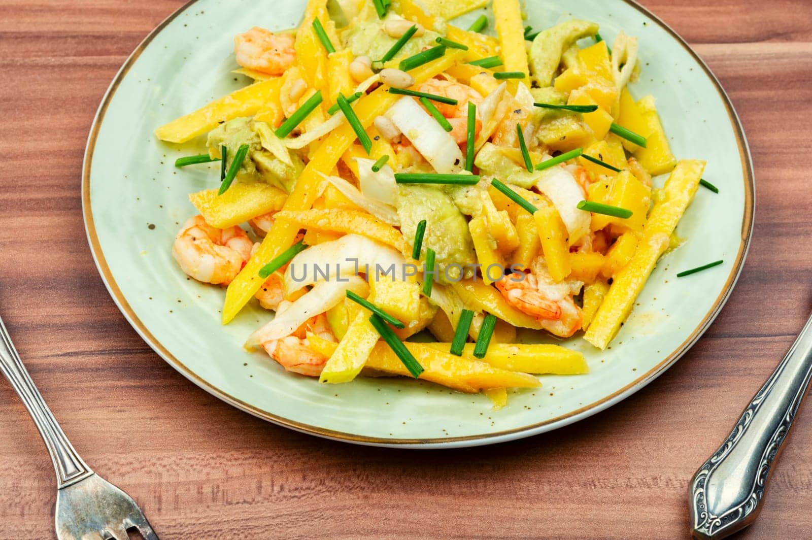 Dieting fresh salad with prawns, mango, avocado and pine nuts.