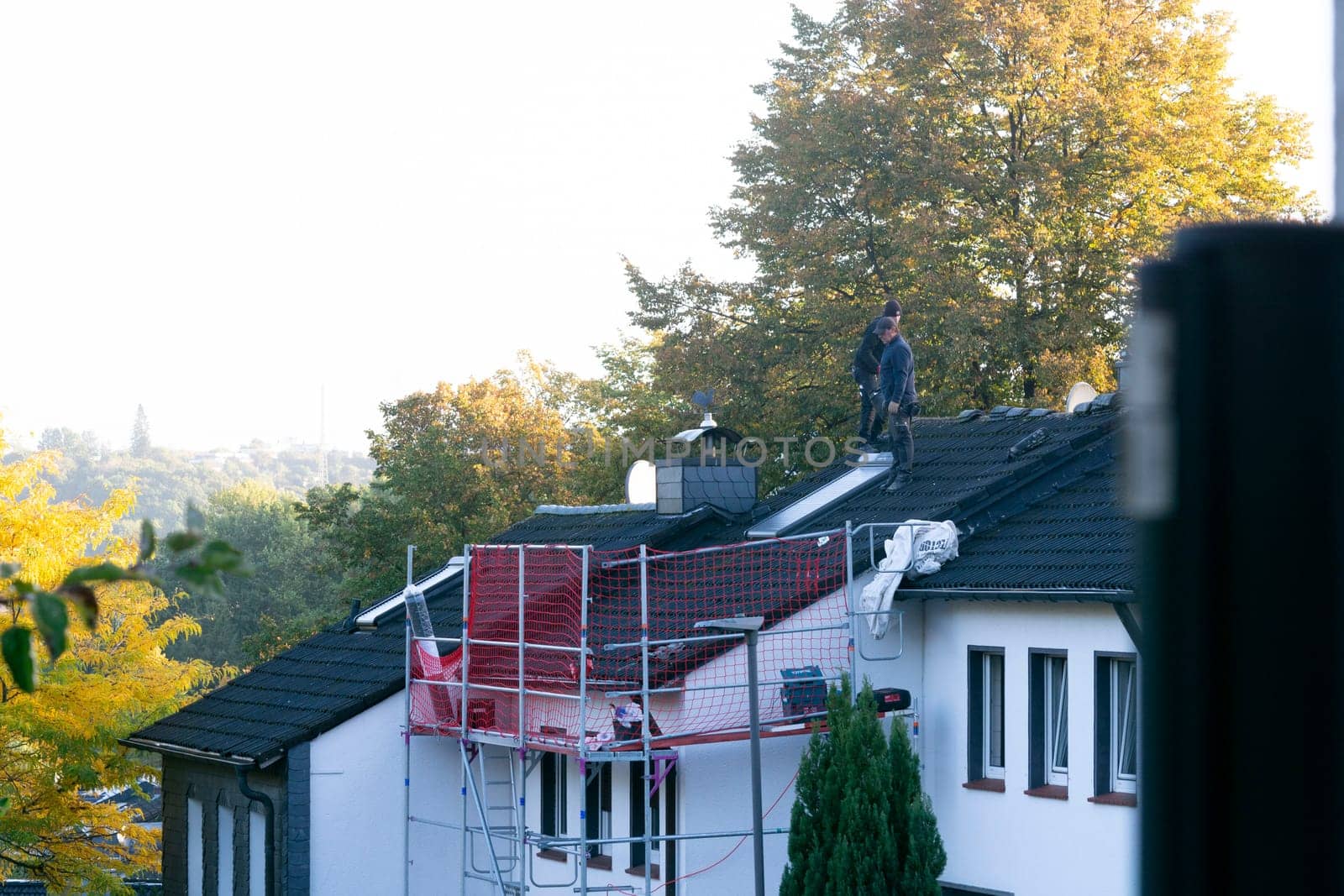 HEILIGENHAUS, NRW, GERMANY - OKTOBER 06, 2022:.Heiligenhaus, Nrw, Germany - Oktober 06, 2022:.Closeup of house roof top covered with ceramic shingles. Tiled covering of building