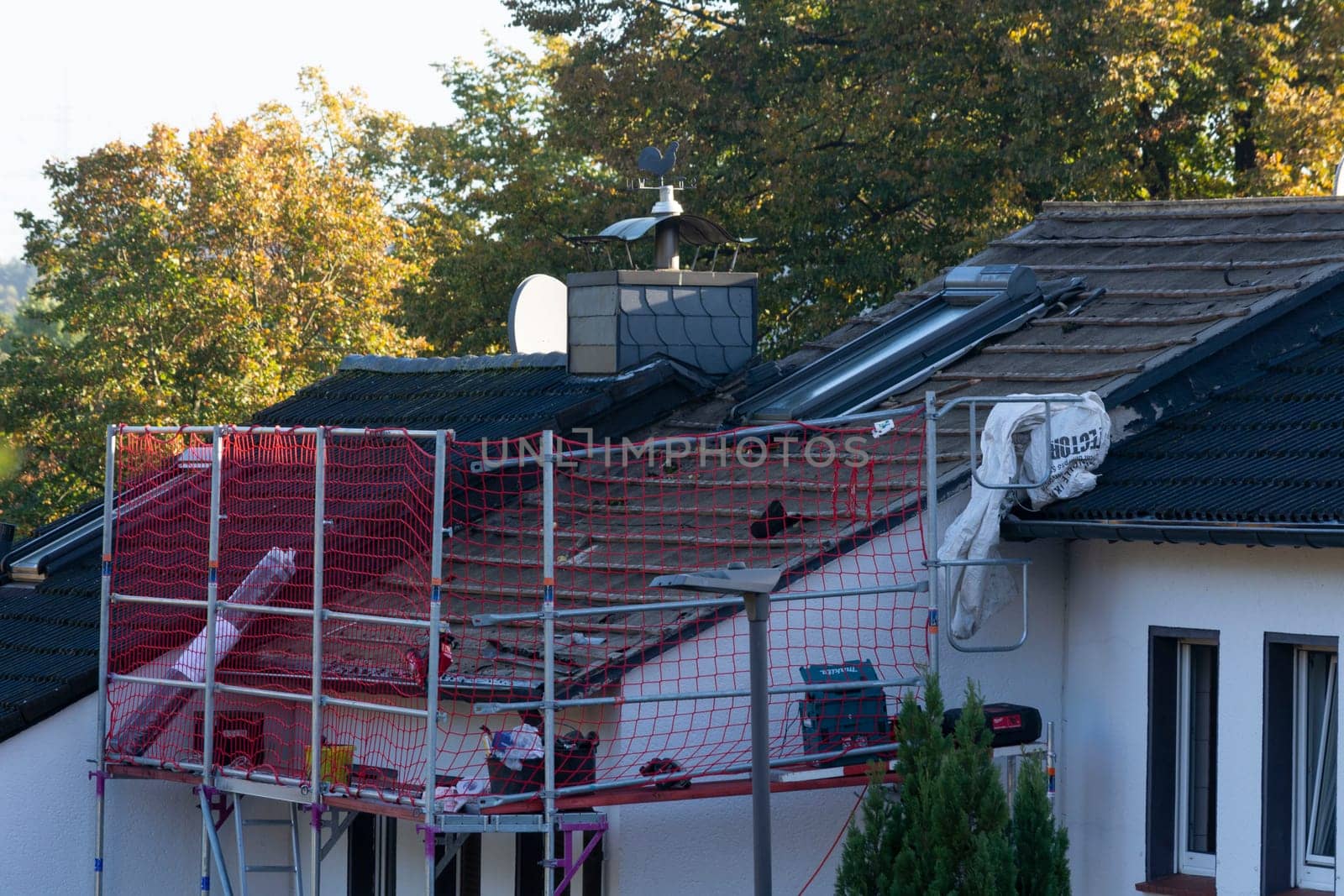HEILIGENHAUS, NRW, GERMANY - OKTOBER 06, 2022:.Heiligenhaus, Nrw, Germany - Oktober 06, 2022:.Closeup of house roof top covered with ceramic shingles. Tiled covering of building