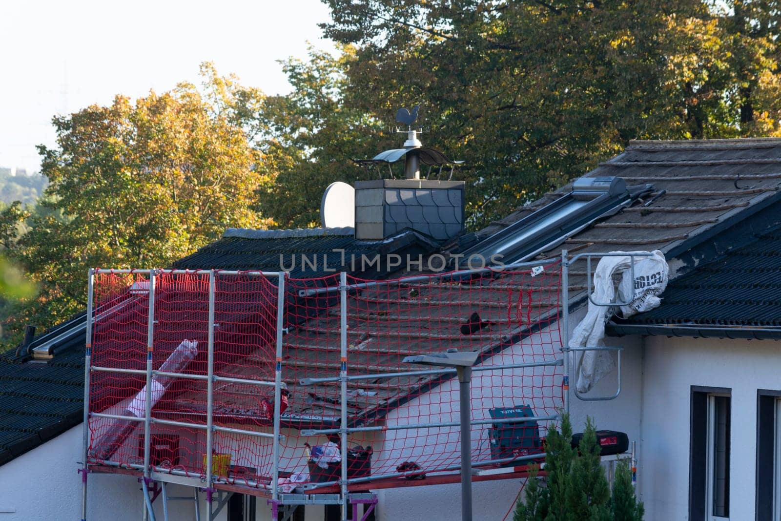 HEILIGENHAUS, NRW, GERMANY - OKTOBER 06, 2022:.Heiligenhaus, Nrw, Germany - Oktober 06, 2022:.Closeup of house roof top covered with ceramic shingles. Tiled covering of building