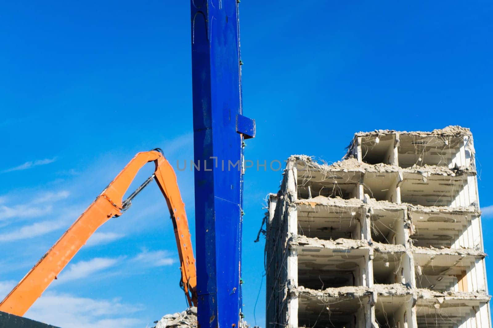 Construction site digger yellow demolishing house for a reconstruction