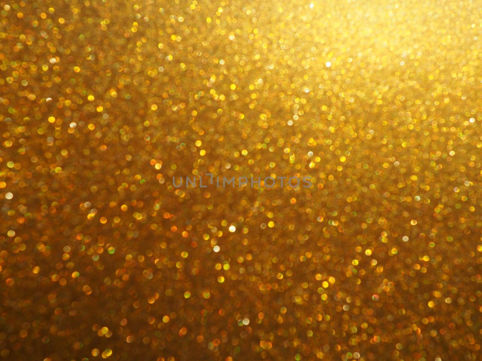 Bokeh light of gold glitters. Golden glitter texture background. Sparkling glitter wrapping paper with sequins and sparkles. Festive golden bokeh and glitter. Beautiful background