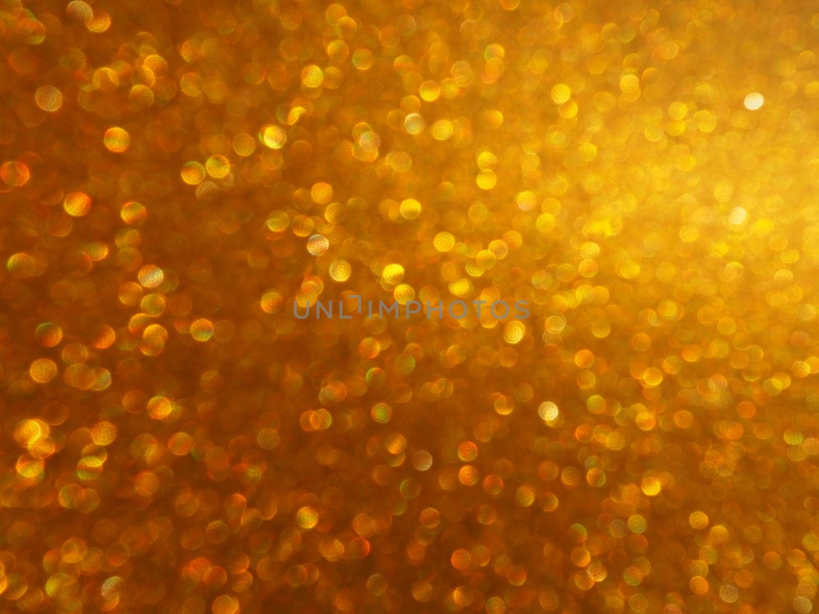 Bokeh light of gold glitters. Golden glitter texture background. Sparkling glitter wrapping paper with sequins and sparkles. Festive golden bokeh and glitter. Beautiful background