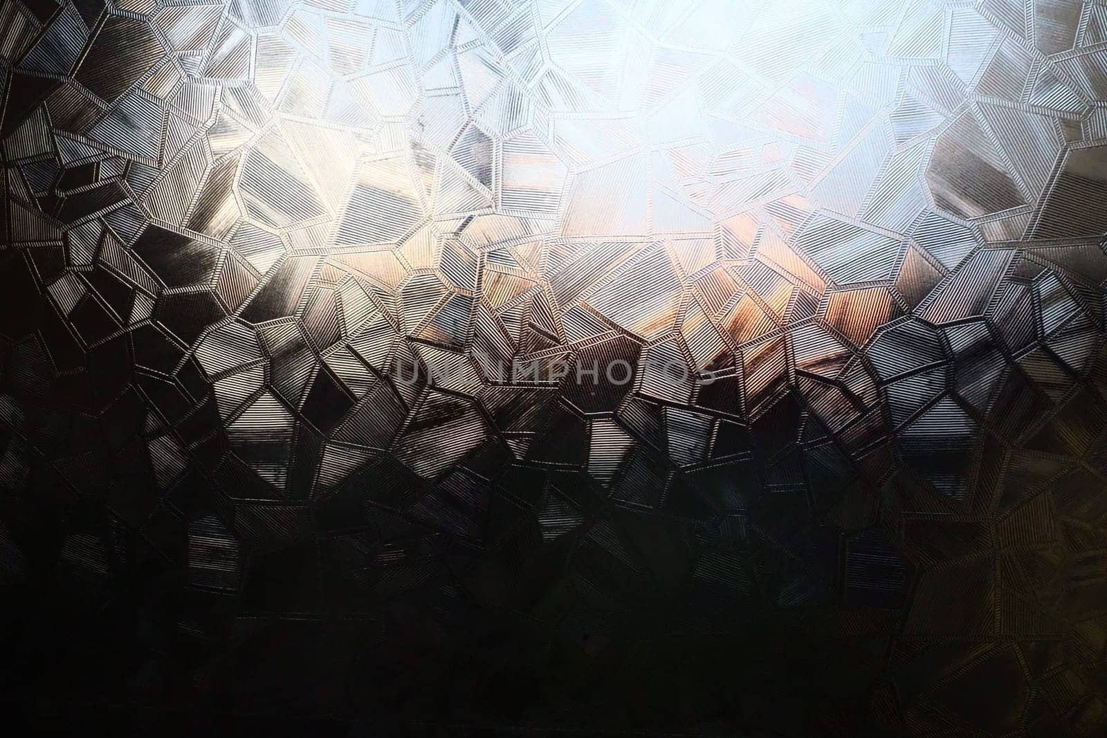 Fluted glass with backlight. Beautiful multicolored refraction of light. Abstract background. Self-adhesive film. Ribbed glass surface. Embossed glass background.