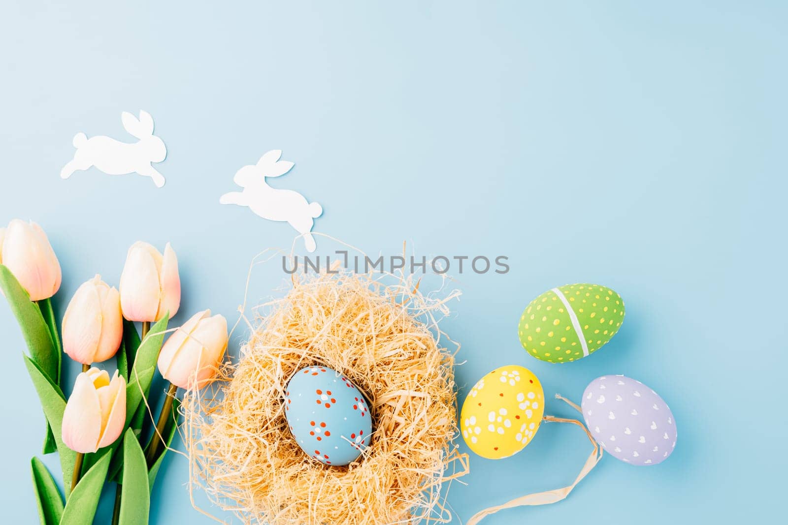 Happy Easter Day Concept. Flat lay of holiday banner background web design easter eggs in brown nest on white cement background with empty copy space, celebration greeting card, overhead, template