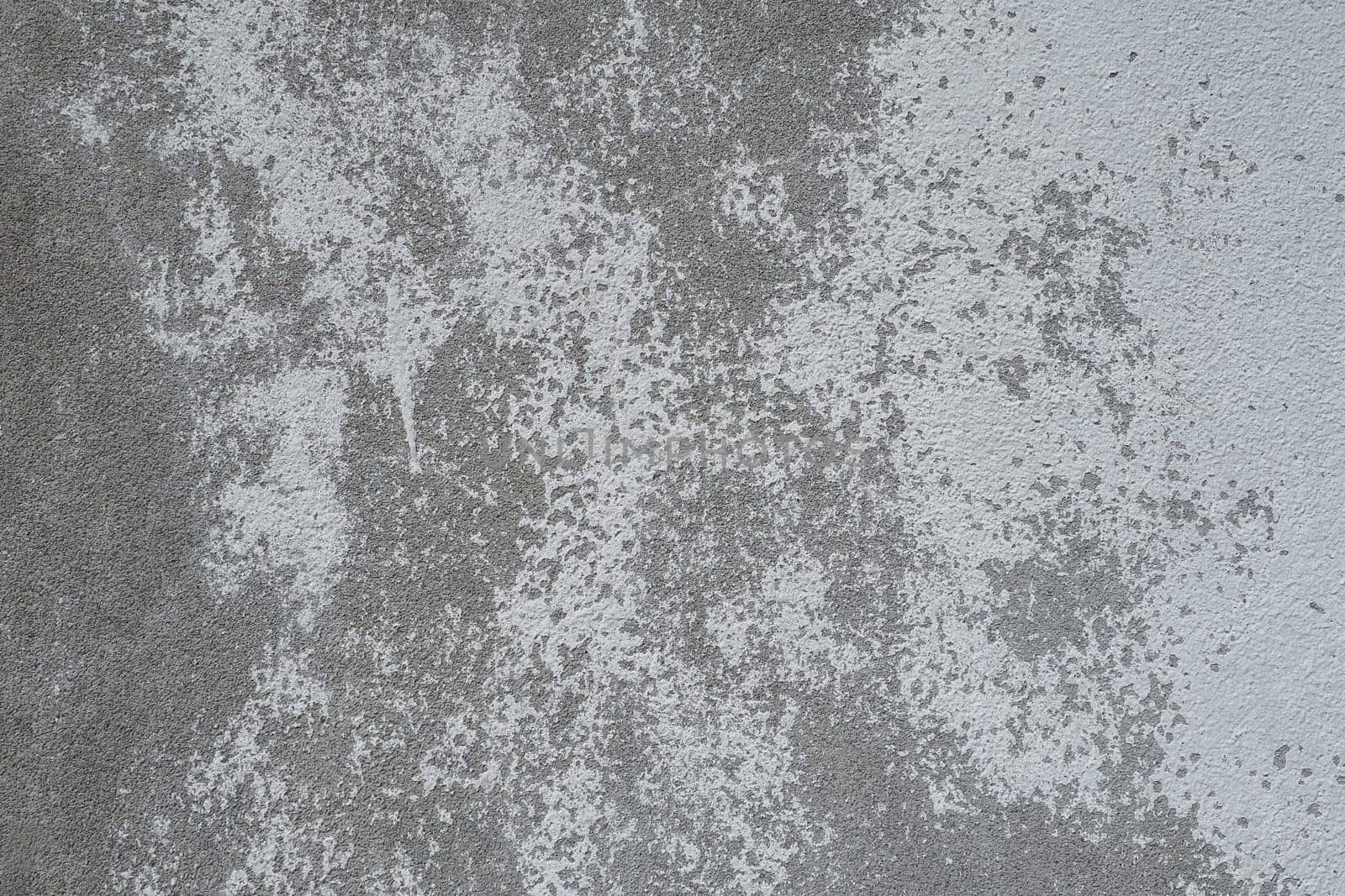 Plastered wall texture. Whitewash surface. Abstract background. Retro wall built structure texture. Cracks and bumps on the concrete wall. Uneven coloring with water-based paint. Old tattered plaster.
