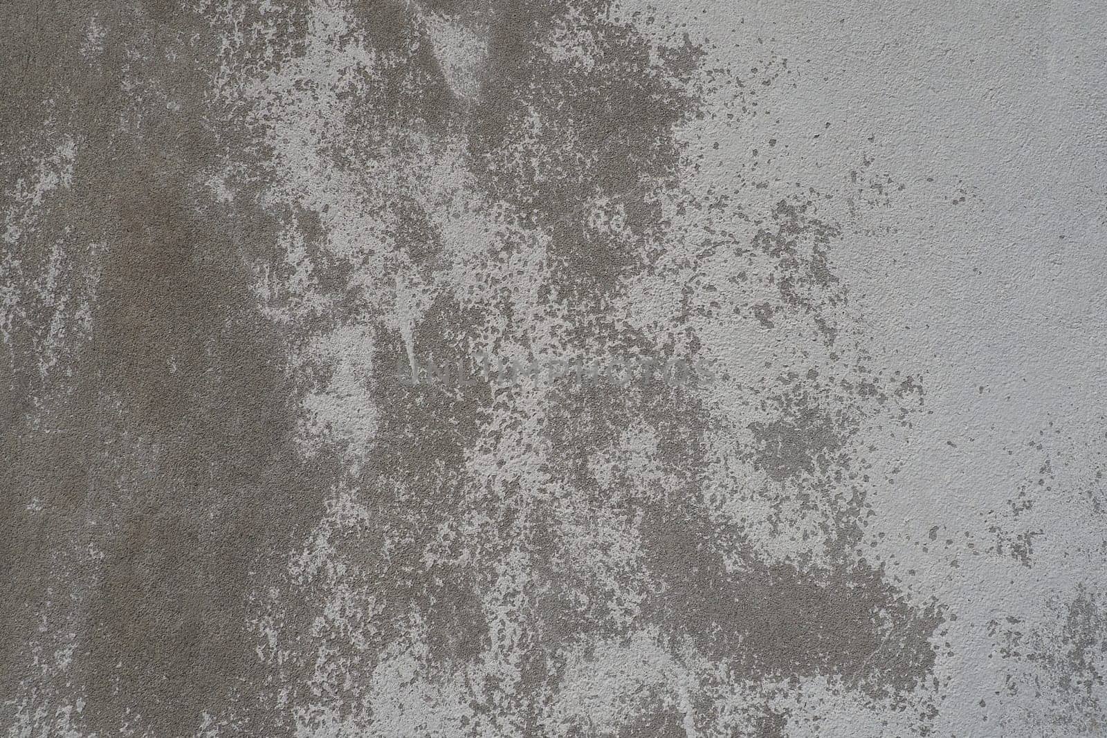 Plastered wall texture. Whitewash surface. Abstract background. Retro wall built structure texture. Cracks and bumps on the concrete wall. Uneven coloring with water-based paint. Old tattered plaster.