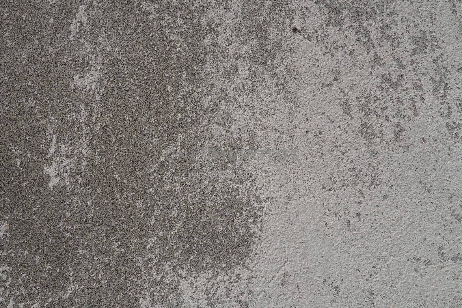 Plastered wall texture. Whitewash surface. Abstract background. Retro wall built structure texture. Cracks and bumps on the concrete wall. Uneven coloring with water-based paint. Old tattered plaster.