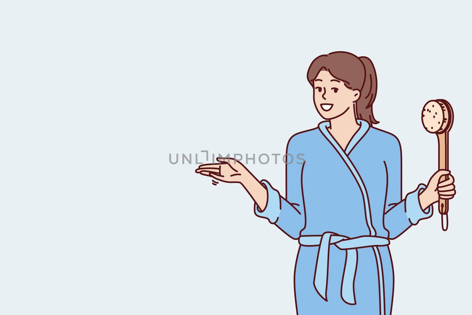 Woman in bathrobe holding shower brush in hand going to take bath and do self bodycare or anti-aging treatments. Positive girl after shower points to side, drawing your attention to importance hygiene