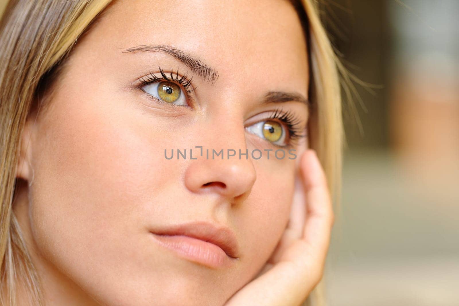 Close up of a distracted woman with beautiful eyes looking away