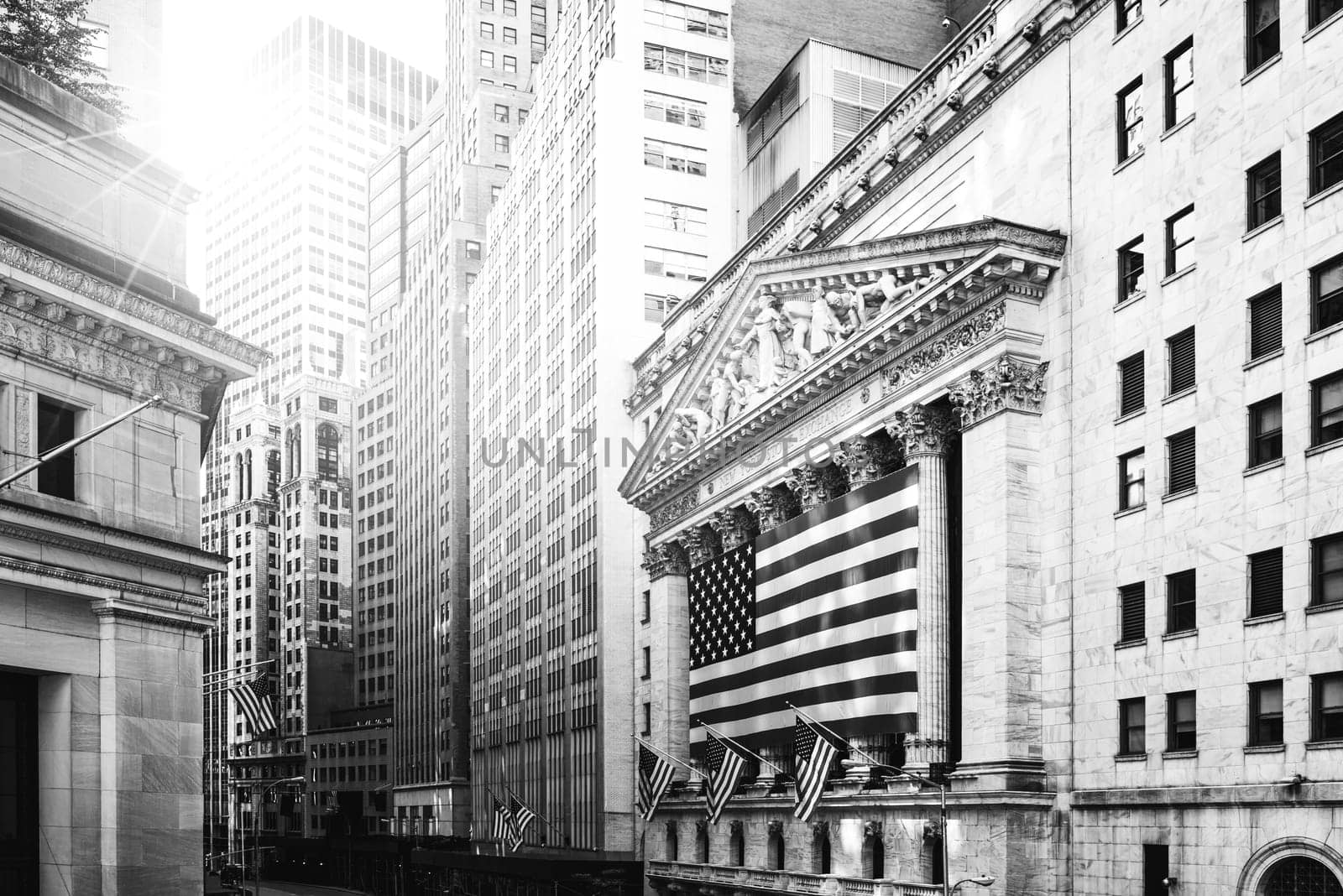 Famous Wall street and the building in New York, New York Stock Exchange with patriot flag