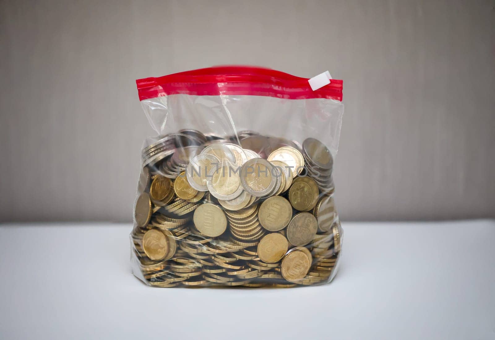 Many coins, euros stored in a plastic bag.