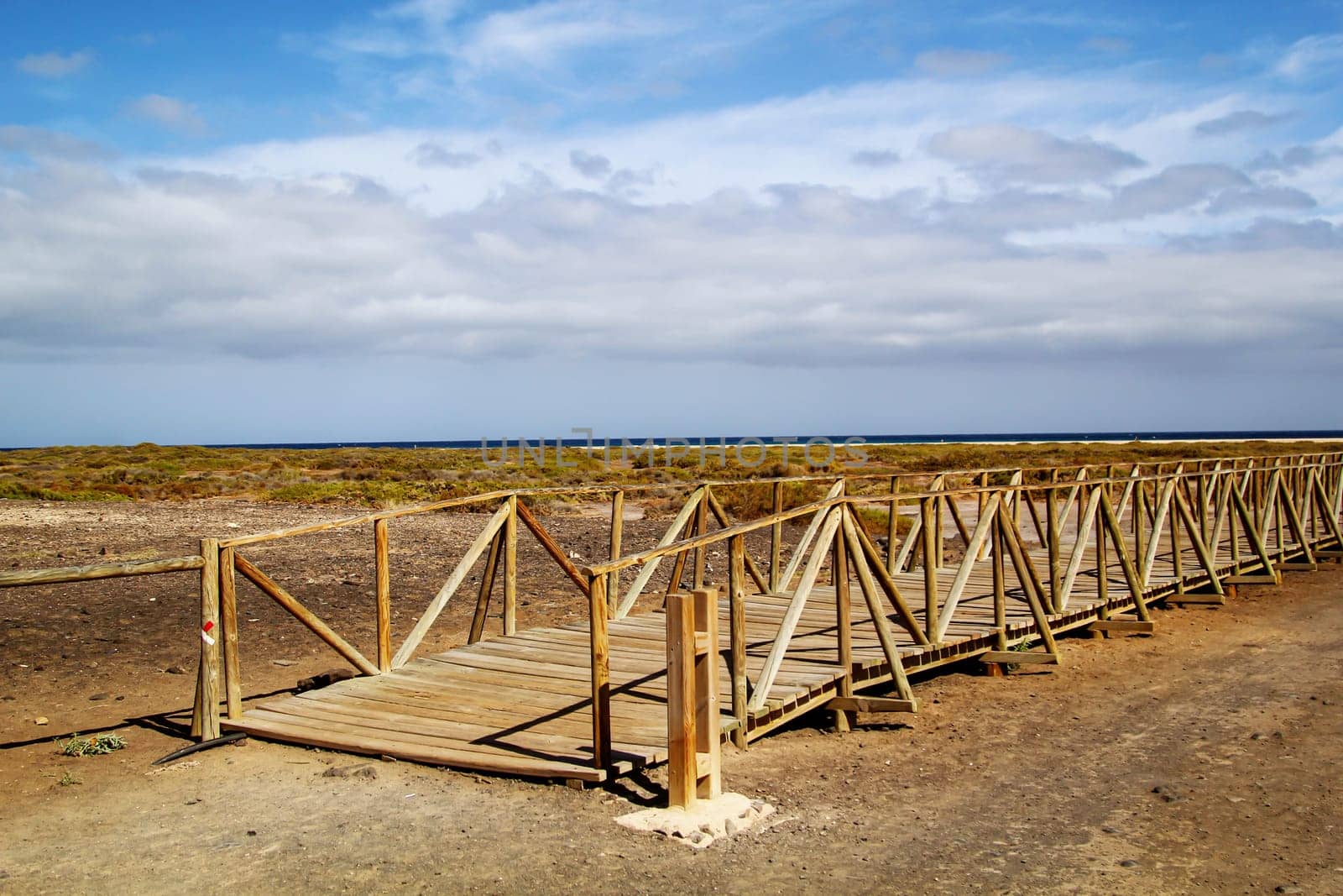 Through a wooden walkway, beachgoers are guided through the nature worth protecting without damaging it.