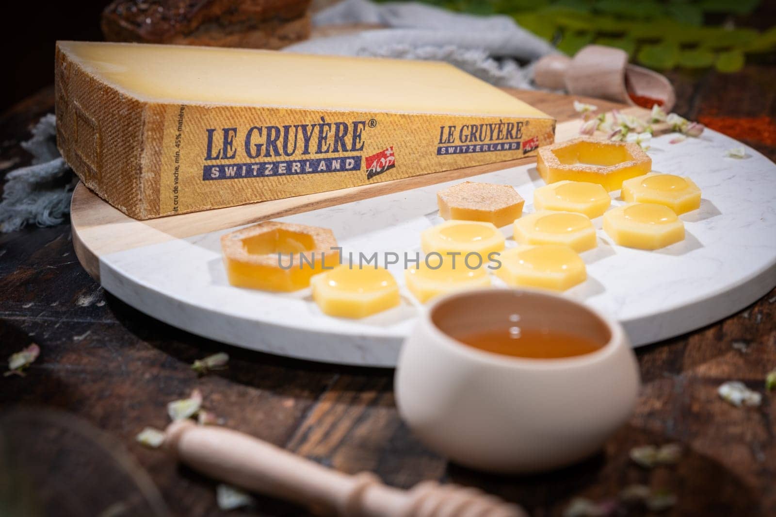July 12 2022, Lyon, France : Tasted famous swiss cheese : Le Gruyère d'Alpage with honey for lunch and food experience