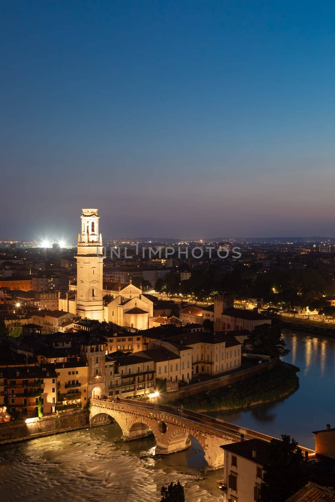 Verona, Italy - June 2022: panorama by night. Illuminated cityscape with scenic bridge