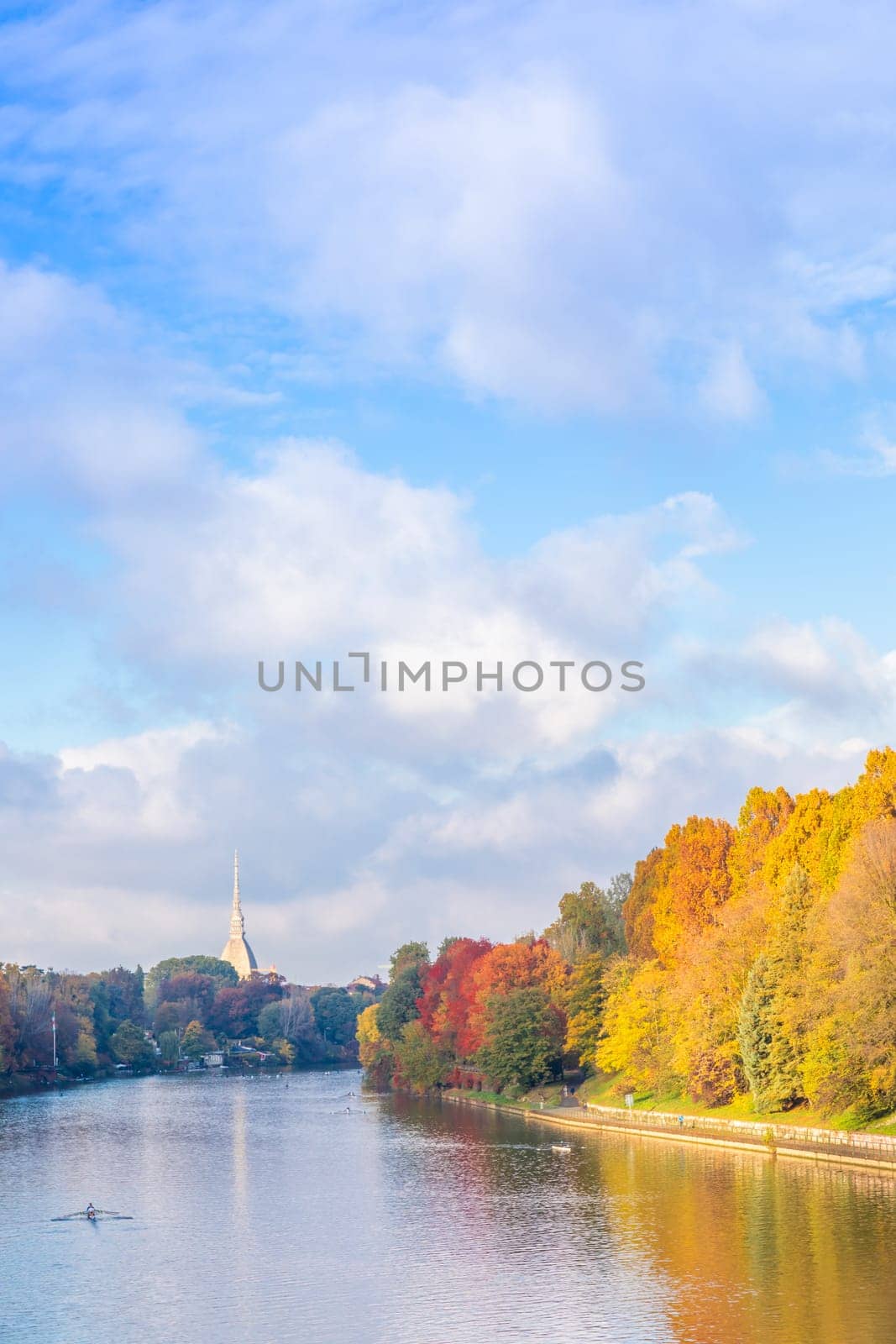 Turin, Piedmont Region, Italy - Circa November 2021: landscape in autumn with Po' river and blue sky.