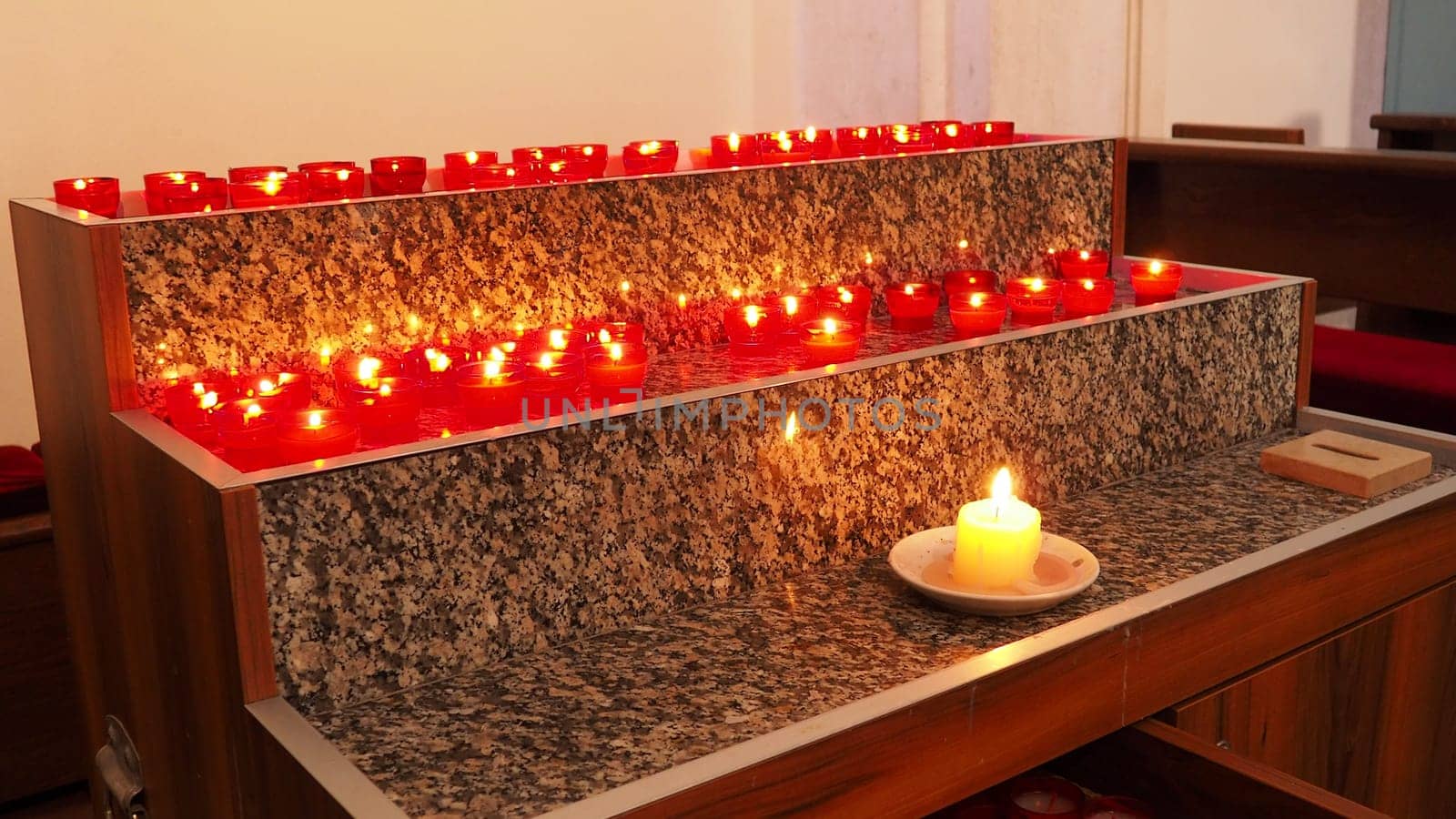 Memorial Day with candle. Commemorative candles are lit. Candle flames burn in the cemetery. Burning candles in the catholic church in Dubrovnik Croatia. Lots of candles. The flame sways in the draft