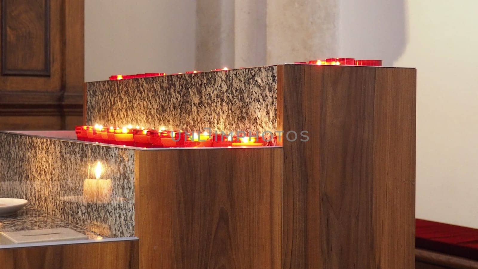 Memorial Day with candle. Commemorative candles are lit. Candle flames burn in the cemetery. Burning candles in the catholic church in Dubrovnik Croatia. Lots of candles. The flame sways in the draft