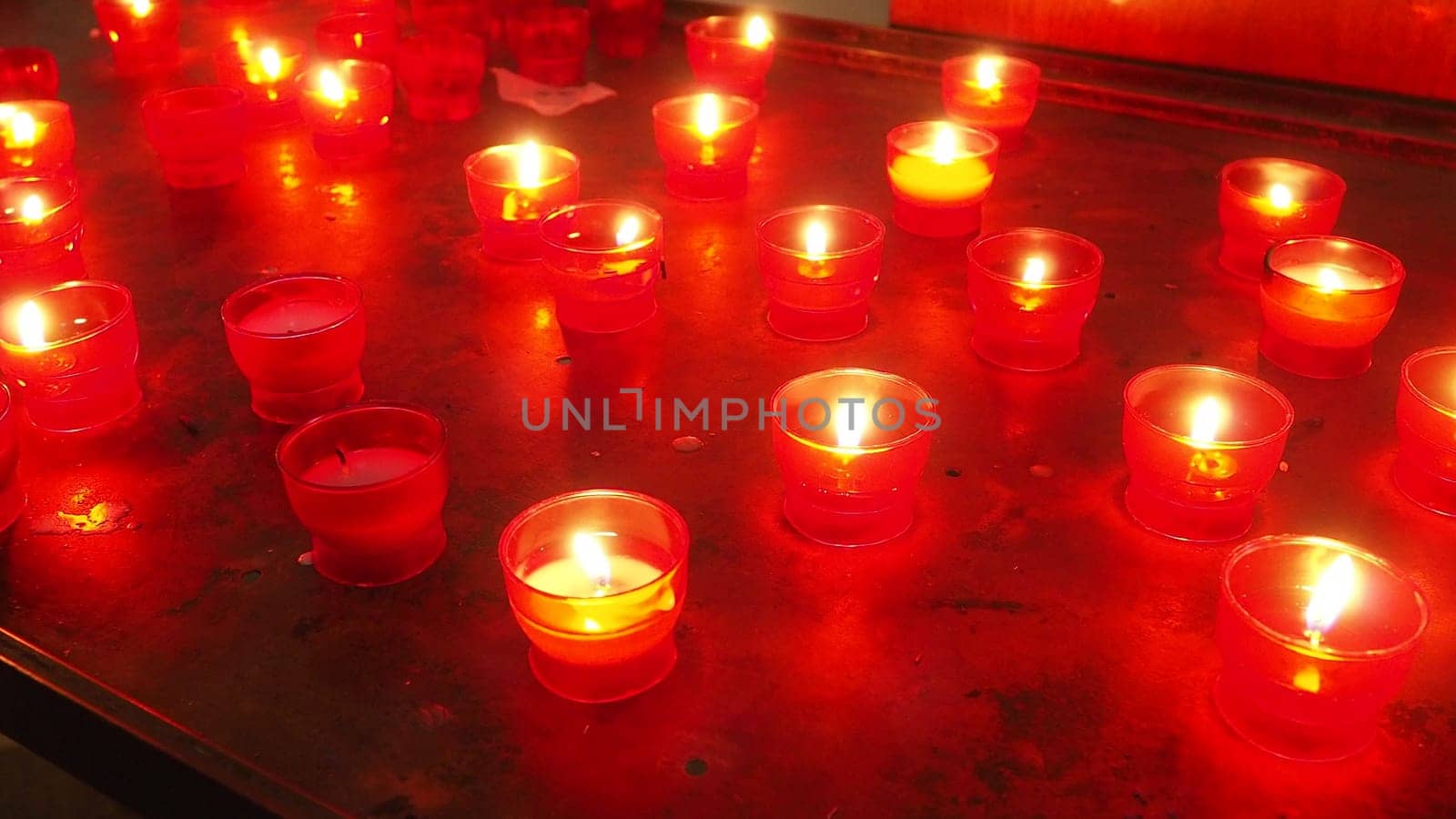 Memorial Day with candle. Commemorative candles are lit. Candle flames burn in the cemetery. Burning candles in the catholic church in Dubrovnik Croatia. Lots of candles. The flame sways in the draft