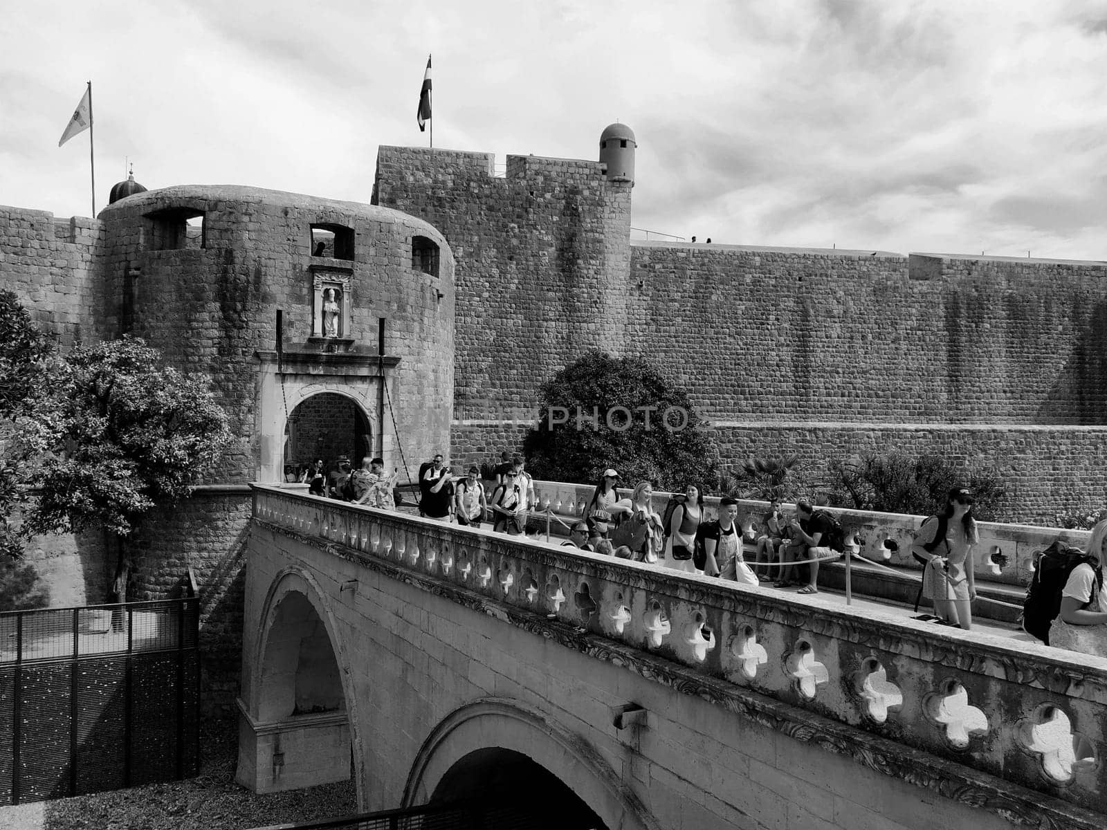 Pile Gate Dubrovnik Croatia August 14 2022 People men and women walk along the stone bridge to the gate of the Old City. Crowd of tourists. Busy entrance. The main entrance to Old Town, busy Pile Gate