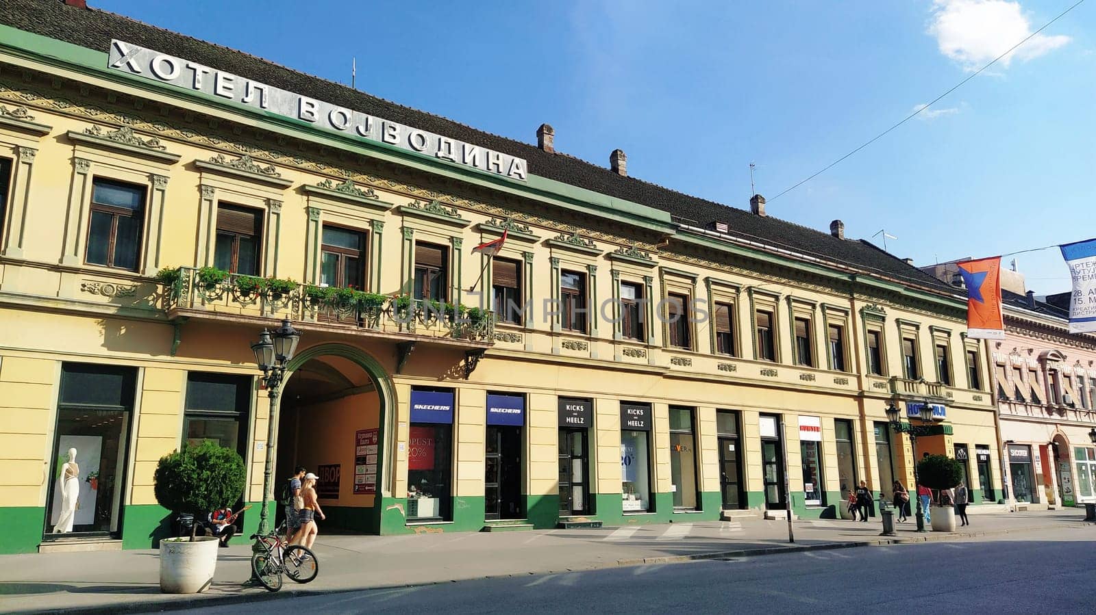 Novi Sad, Serbia 30 April 2022 Hotel Vojvodina is the oldest hotel in the center of the city. European tourism facility. Street with passers-by. Freedom Square. Hotel with rooms provision of services.
