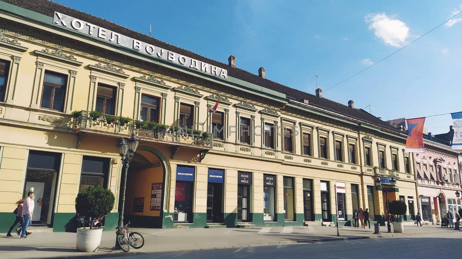 Novi Sad, Serbia 30 April 2022 Hotel Vojvodina is the oldest hotel in the center of the city. European tourism facility. Street with passers-by. Freedom Square. Hotel with rooms provision of services.