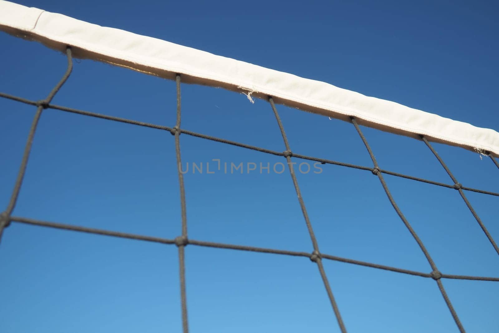 Volleyball sports dividing net against the blue sky close-up. Outdoor sports.