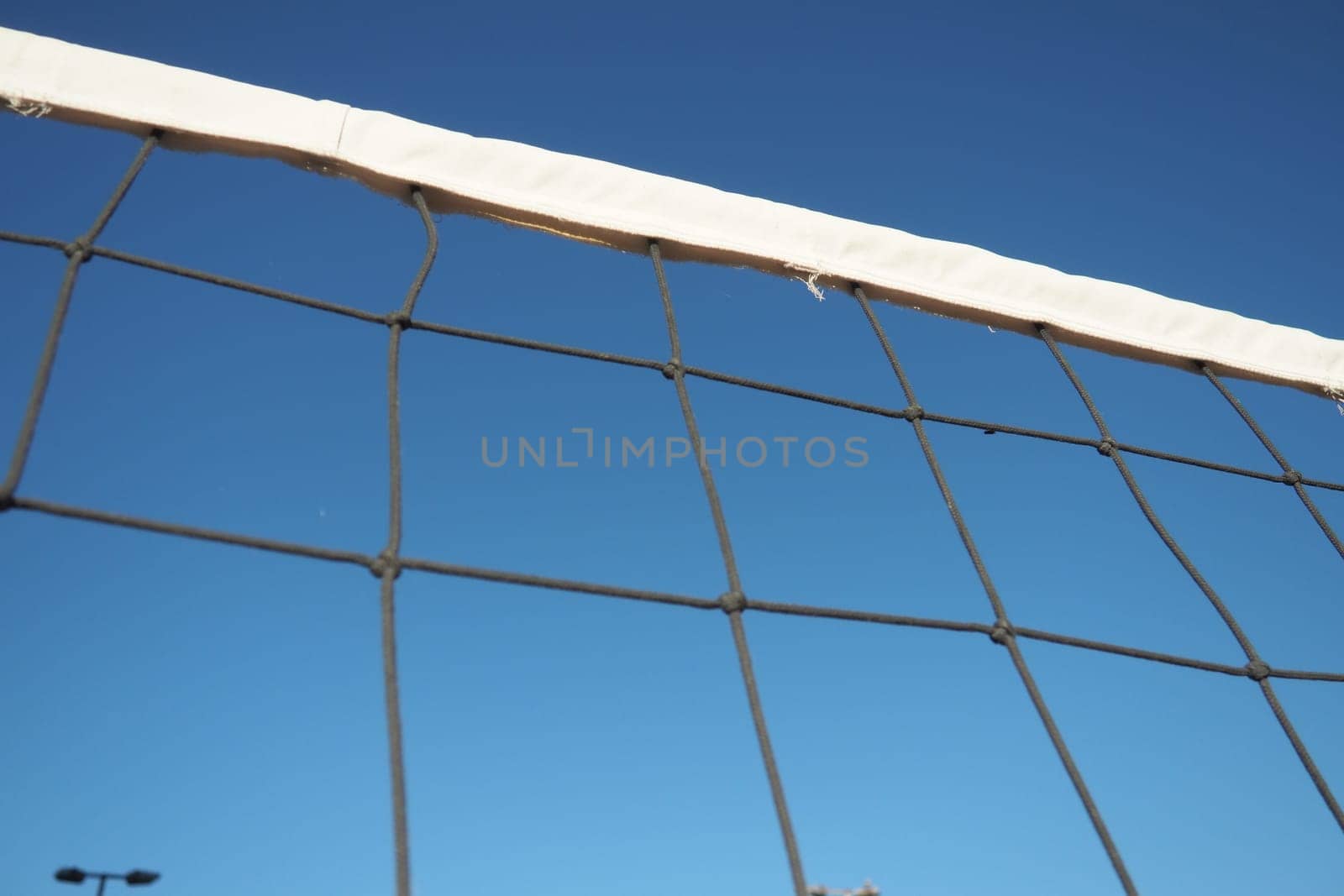 Volleyball sports dividing net against the blue sky close-up. Outdoor sports.