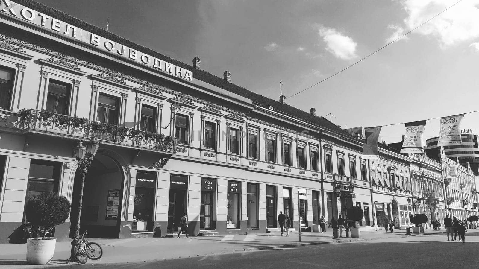 Novi Sad, Serbia 30 April 2022 Hotel Vojvodina is the oldest hotel in the center of the city. European tourism facility. Street with passers-by. Freedom Square. Hotel with rooms provision of services.