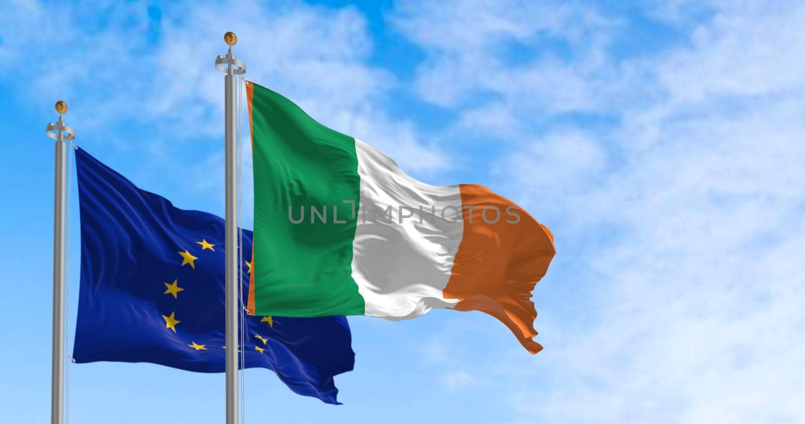 The flags of Ireland and the European Union fluttering together on a clear day. Ireland became a member of the European Union on 1973. 3d illustration render. International treaty and diplomacy