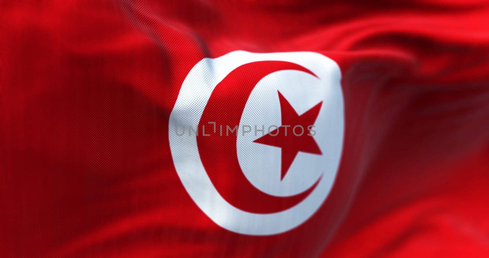 Detail of the Tunisia national flag waving. Red with white circle in center, red star and crescent within circle. Maghreb region. Fabric textured background. Selective focus. 3d illustration render