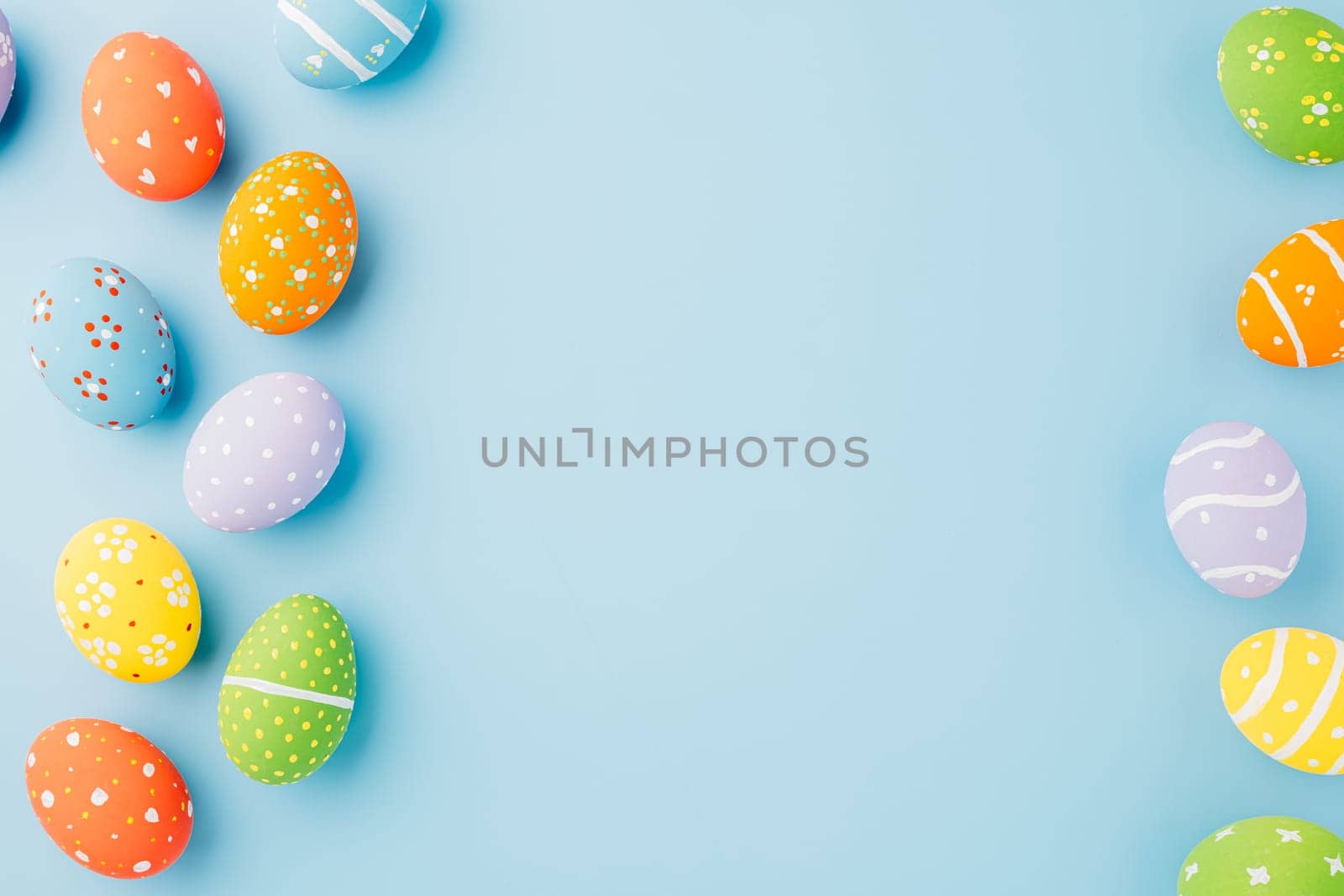 Colorful easter eggs isolated on blue background with copy space, Funny decoration, Creative composition banner web design holiday background, Happy Easter Day greeting card, flat lay top view